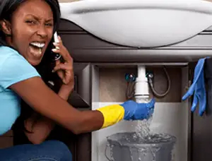 Emergency plumbing repair for a leaking sink drain under a bathroom vanity in San Diego, CA
