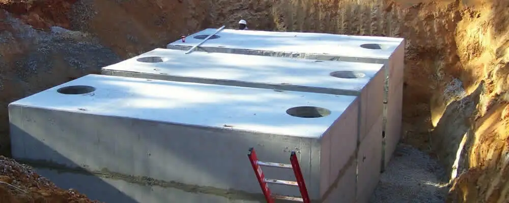 Septic tank installation site with a newly placed concrete tank in San Diego, CA